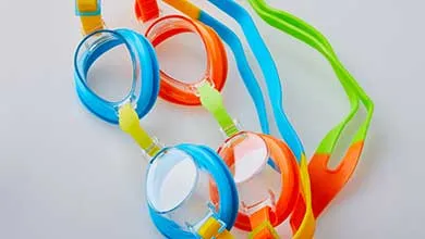 Two pairs of swim goggles that are blue and orange