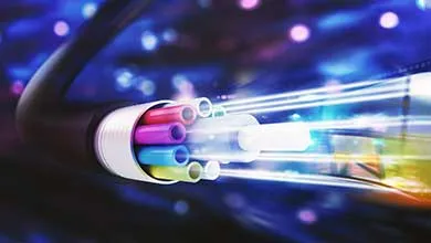Close-up cross-section of a fiber optic cable with colorful inner tubes and bright light shining from their ends.